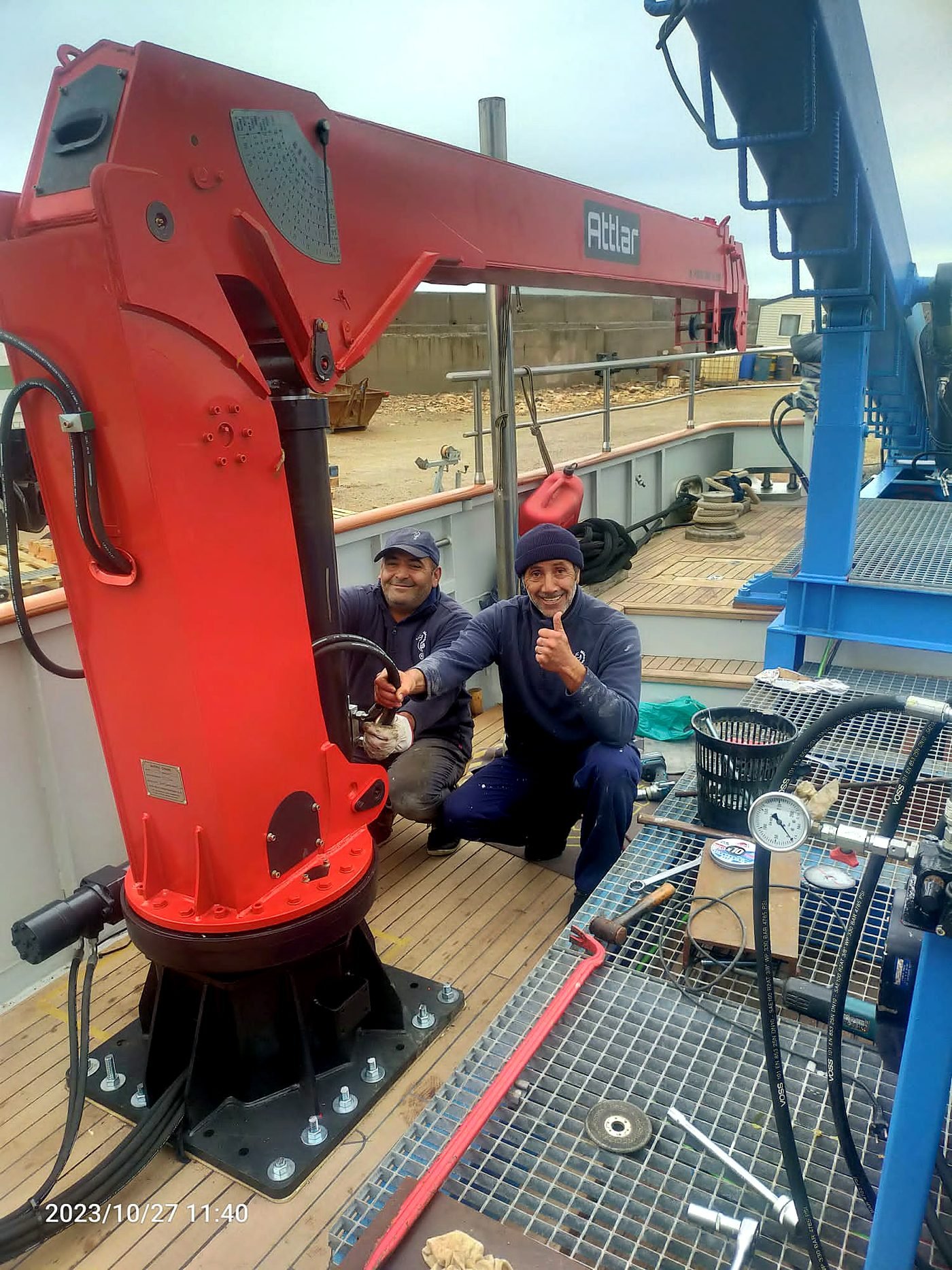 GPS lattice crane on a barge over water for marine and waterway engineering
